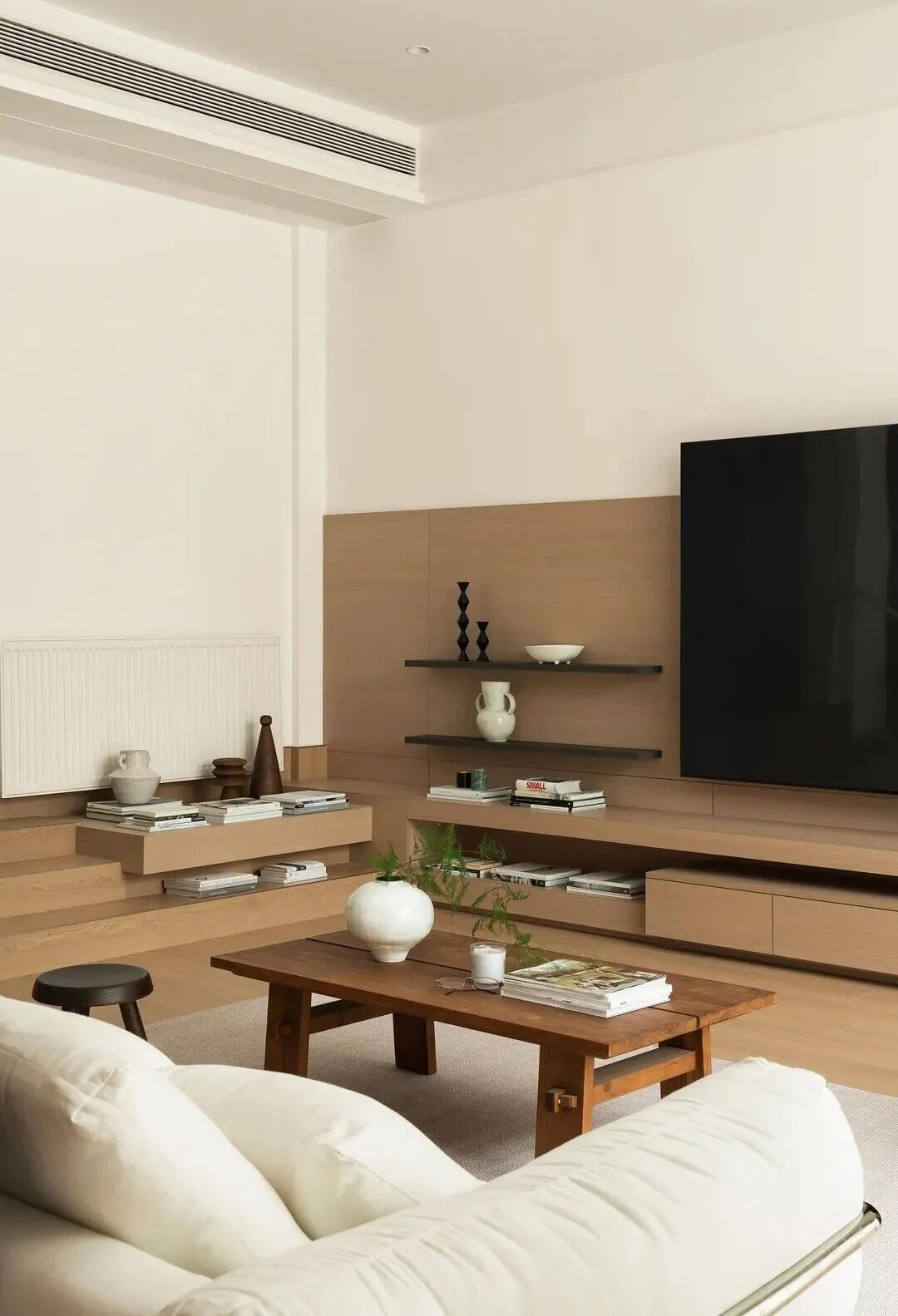 Modern duplex living room with minimalist decor, neutral tones, and stylish furniture in an undefined open space